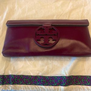 Tory Burch Burgundy logo clutch. 11in width x 5 in height. Brand New. Never Used